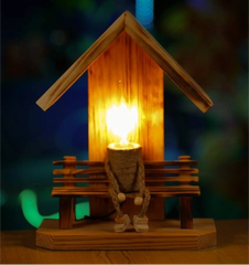 man sitting on a bench wooden handmade lamp 